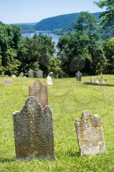 Old mossy and lichen covered grave markers in cemetery above Harpers Ferry in West Virginia