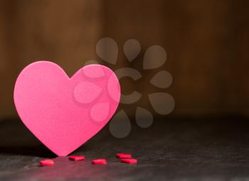Heart shaped cutouts on textured surface and background for Valentines day with copy space
