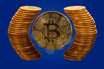 Single bitcoin coin with pure gold coins reflected in glass surface to give illusion of being surrounded by ring of gold to illustrate wealth