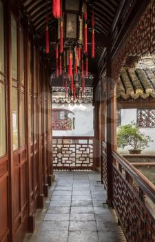 Entrance into small courtyard with tree planting in Yu or Yuyuan Garden in  the old city of Shanghai