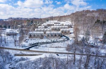 View of modern townhouses covered with winter snow on hill overlooking Cheat Lake near Morgantown West Virginia