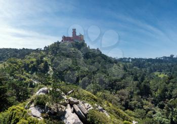 Pena Palace monument on the hilltop seen from the Castle of the Moors near Sintra in Portugal