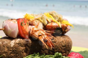Fried lobster with vegetables and seafood. Cooking seafood in the open air.