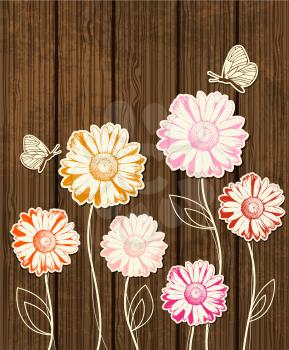 Chamomile flowers and butterflies on wooden background
