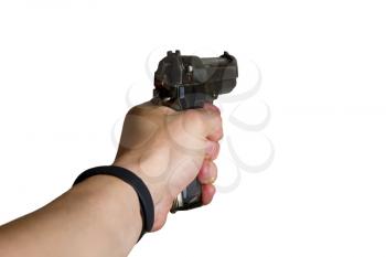 man's hand holds a gun with a cocked trigger in front of him isolated on a white background