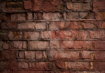 the old weathered wall of red painted bricks