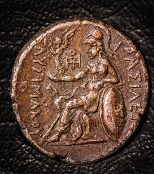 ancient greek coin tetradrachm on a dark background