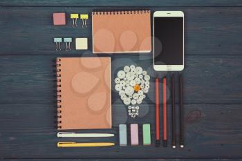 Idea concept - phone, watch, notepads, pencils and colorful office supplies