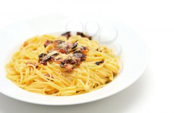 Traditional Italian food Spaghetti Carbonara with pancetta, egg and parmesan on white plate.