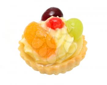 Closeup of cupcake with vanilla cream, pieces of fruits and gelatine topping. Isolated on white background.