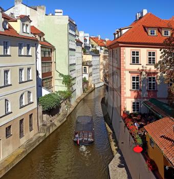 Certovka river (part of Vltava river and Kampa island) with tourist boat in Prague.