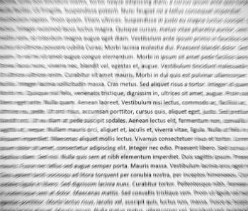 Closeup of lorem ipsum text on white paper, abstract zoom effect.