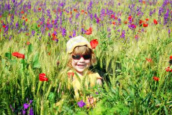 Happy little girl on the meadow