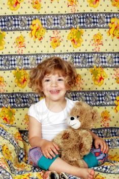 Happy little girl with teddy bear bedtime