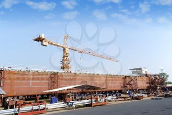 Heavy industry shipyard with crane and tanker