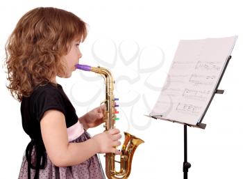 little girl play music on saxophone