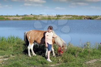 little girl and pony horse 