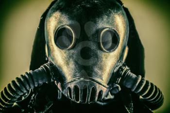 Close up portrait of nuclear post-apocalypse survivor, living underground mutant or creature, skilled stalker wearing rags and armored full-face gas mask or air breathing apparatus, toned shoot