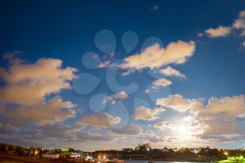 Night scene and sunset with blue clouds, sun and stars 