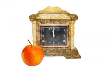 Old table clock and apple isolated on white.