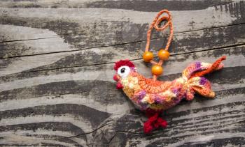 New year 2017 symbol - handmade rooster on a wooden background