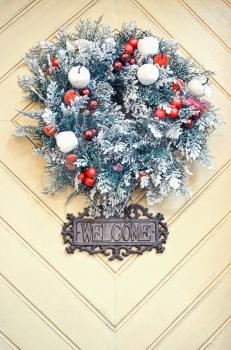 Christmas wreath on wooden door decoration. Christmas time.
