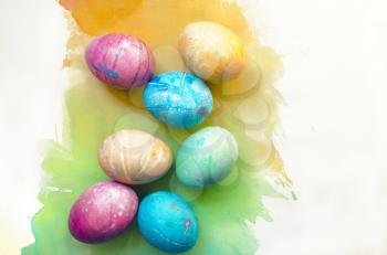 Watercolor background with colorful rainbow Easter eggs.