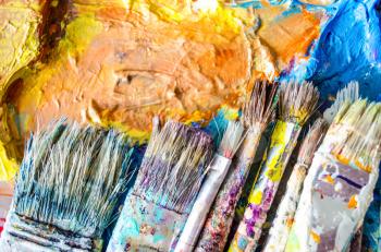Artist paint brushes and palette. Old brushes. Close up.