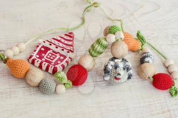 Knitted Toy Hedgehog and Ceramic Christmas House.Toys for the baby sitting in a sling.Sling necklace.