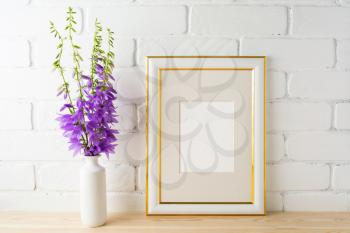 Frame mockup with bluebells bouquet. Portrait or poster white frame mockup. Empty white frame mockup for presentation artwork.