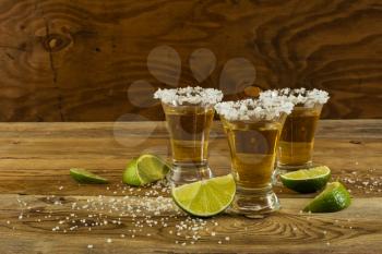 Two gold tequila shots, copy space. Tequila shot. Gold Mexican tequila. Tequila. Alcohol  drink