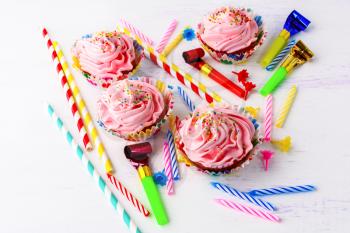 Birthday party concept  with decorated pink cupcakes  and candles. Homemade cupcakes served for party. Birthday greeting  background. 