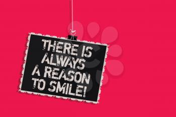 Word writing text There Is Always A Reason To Smile. Business concept for Positive thinking good attitude energy Hanging blackboard message communication information sign pink background