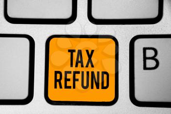 Text sign showing Tax Refund. Conceptual photo applied when money liability is less than the paid ones Keyboard orange key Intention create computer computing reflection document