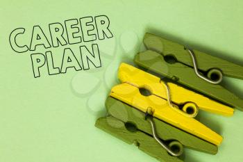 Text sign showing Career Plan. Conceptual photo ongoing process where you Explore your interests and abilities Three green yellow vintage clothespins clear background Holding things