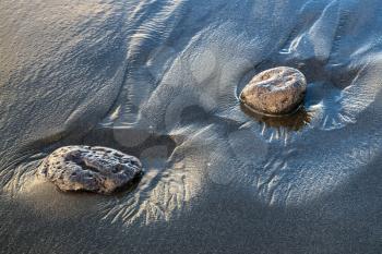 Two Rocks in Volcanic Sand