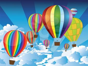 Group of hot air balloons on the blue sky with clouds.