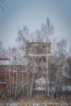 Vintage style red brick building, old factory, winter time landscape.