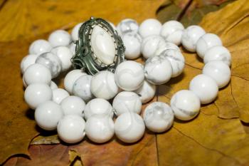 Beads with natural stone white turquoise close up background.
