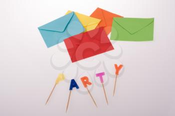 colored envelopes and Color candles on sticks write party