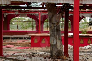 Ruins of an abandoned nightclub. Tattered curtains blowing in the wind.