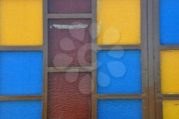Colorful stained glass abstract squares on church window.