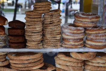 Bakery kiosk with cakes muffins donuts bagels and traditional greek sesame koulouria bread rings. Food snacks.