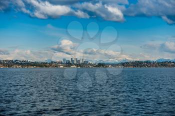 A view of the skyline of Bellevue, Washington with the Cascade Mountains behind.