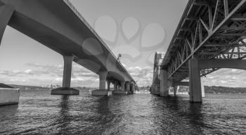 A view from under the I-90 bridge in Seattle, Washington. Black and white image.