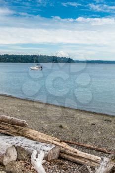 Two boats are anchored in the Puget Sound with Mount Rainier in the distance.