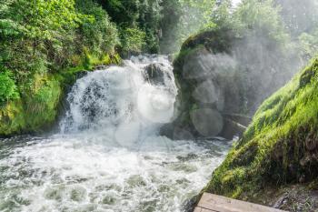 A waterfall bulges out with water in Tumwater, Washington.