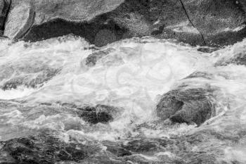 A close-yo shot of rushing whitewater in a Pacific Northwest creek.