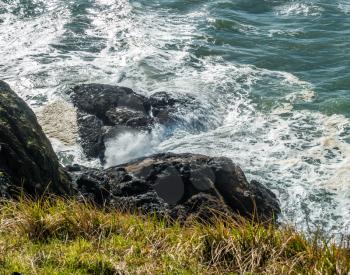 A veiw of a rugged shoreline with whitewater in Washington State.