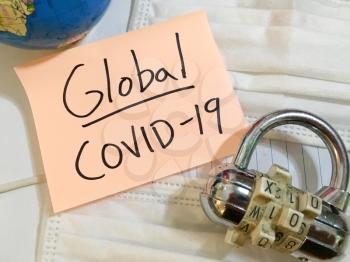 China virus Coronavirus COVID-19 infection global lock down COVID respiratory disease influenza effect on surgical mask and earth globe background